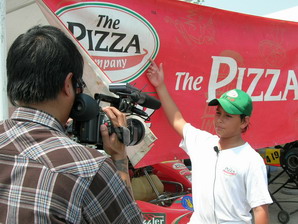 TV interview, explaining about the Pizza Company Racing Team